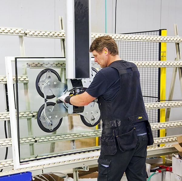 an operator carefully using glass handling equipment for a factory in the United States